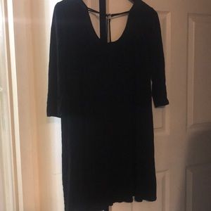 Black dress with gold ring in-front.